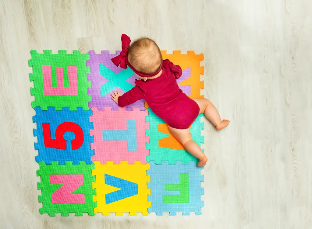 Baby crawling on colorful foam tiles showcasing the benefits of baby play mats for early development