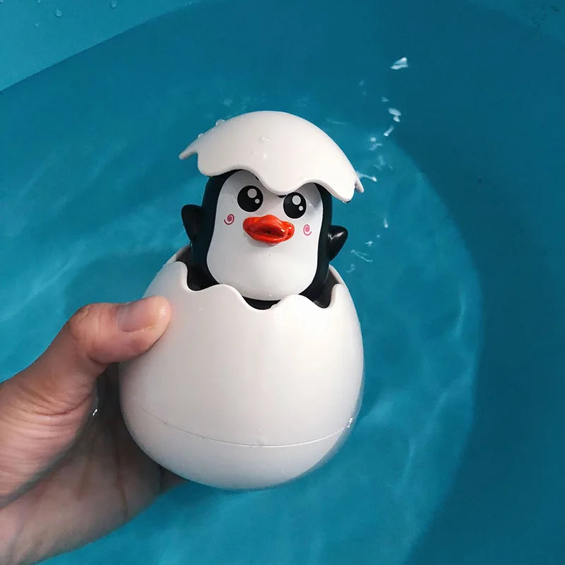Cute penguin baby bath toy water spray that pops from an egg for fun bath time activities