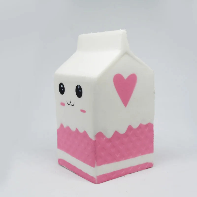 Cute milk carton squishy toy featuring a smiling face and pink heart design for stress relief
