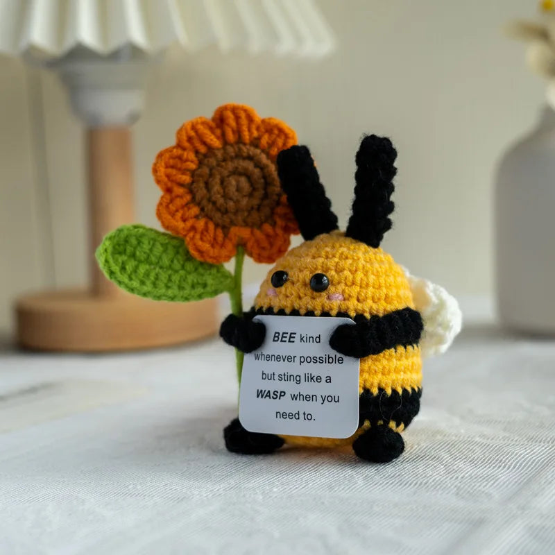 Handmade crochet emotional support buddies in a bee design holding a flower with a positive message