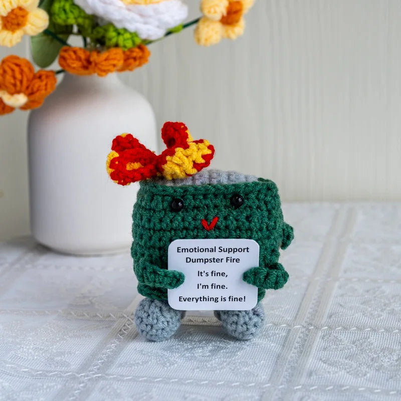 Handmade crochet emotional support buddies in the form of a green dumpster fire toy with a cheerful expression