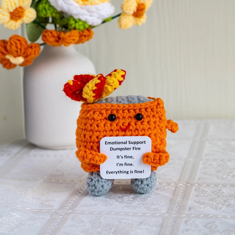 Handmade crochet emotional support buddies shaped as a playful dumpster fire holding a sign that reads Everything is fine