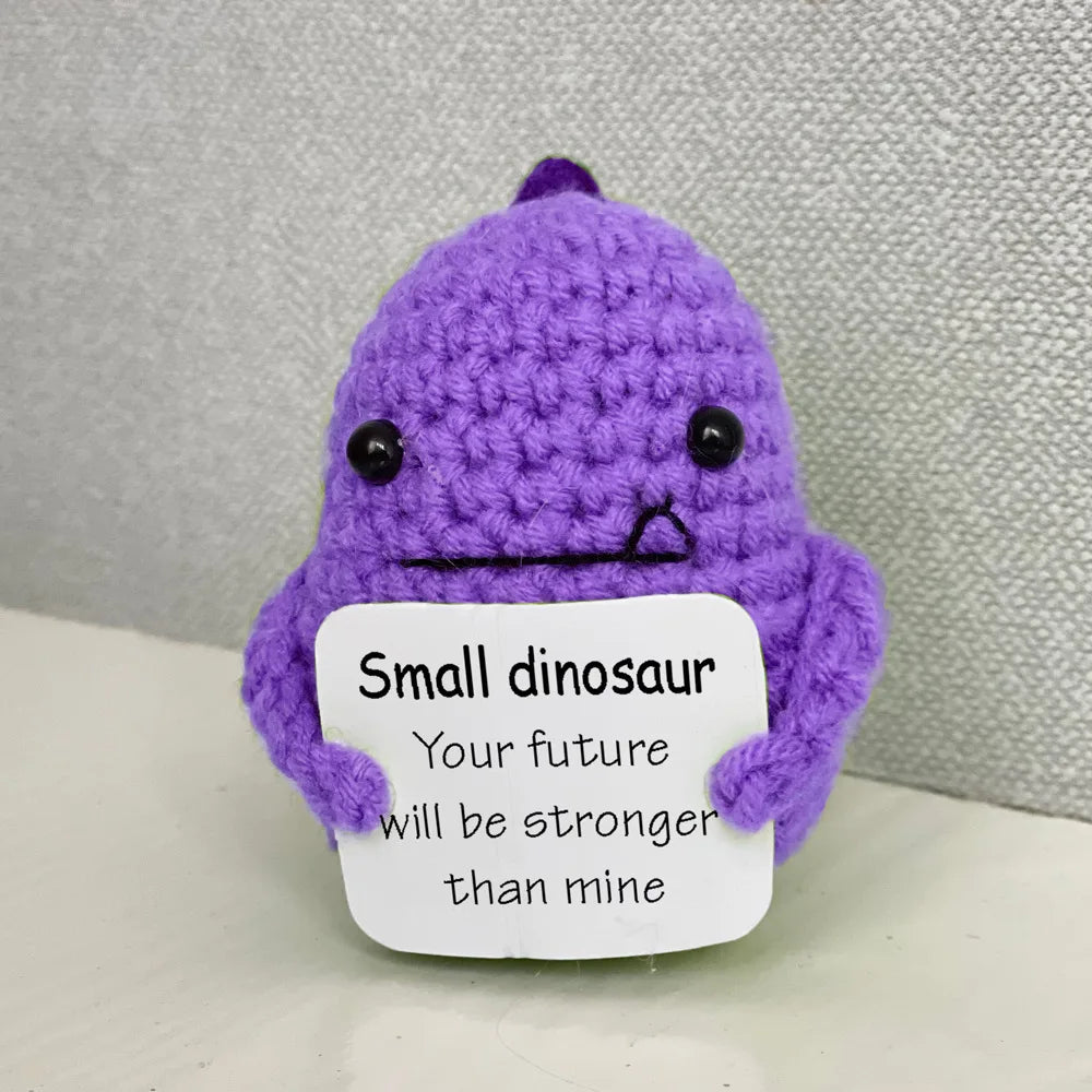 Handmade crochet emotional support buddies in purple dinosaur design with a motivational message