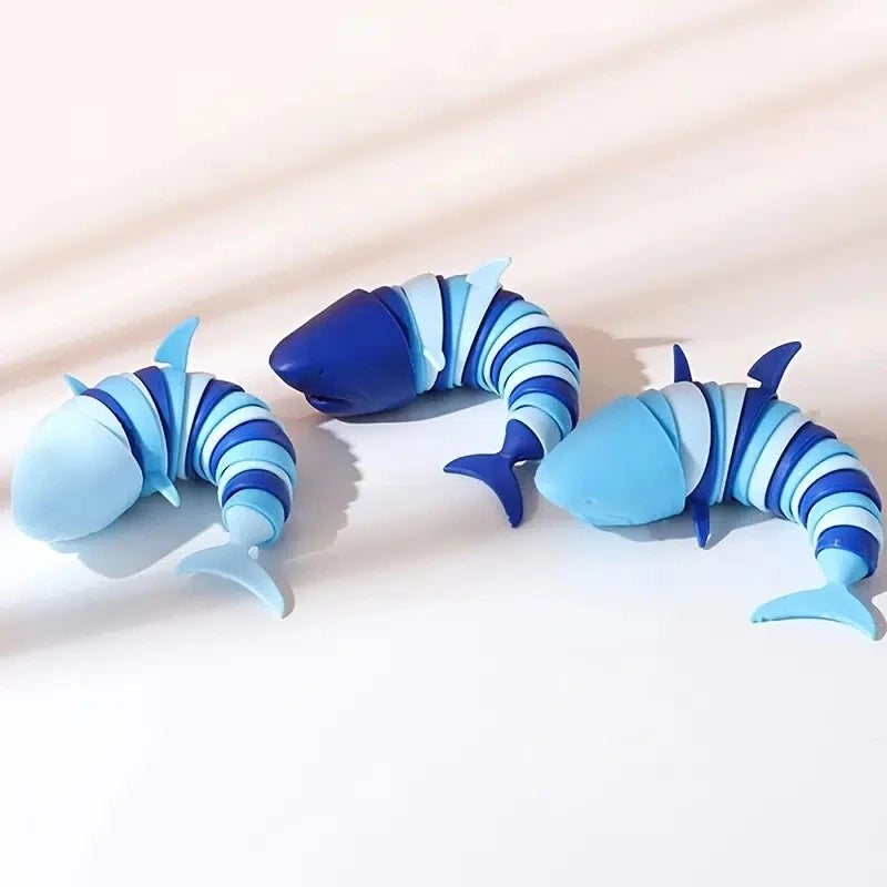 Three colorful shark stress reliever toys in blue and white spiral design for stress relief and fun