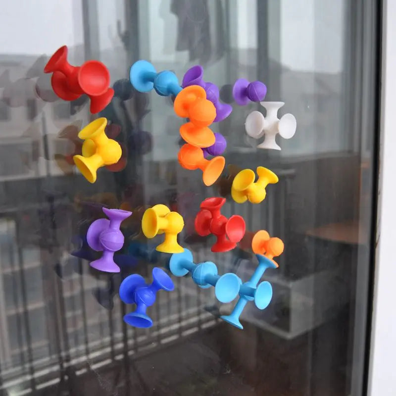 Colorful suction cup dart set stuck to a window, perfect for indoor play and fun activities