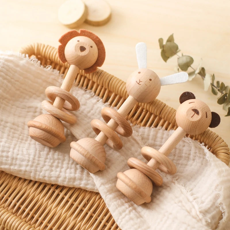 Set of three therapeutic baby rattles featuring animal designs: lion, rabbit, and bear