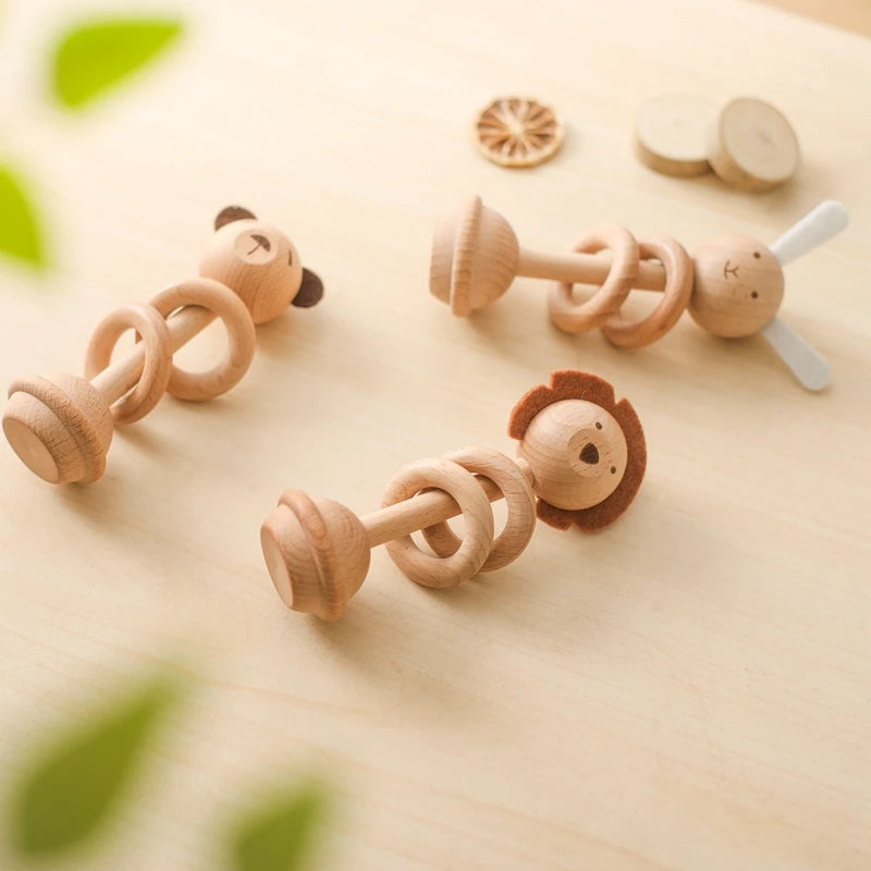 Set of wooden therapeutic baby rattles in animal shapes for sensory play and development