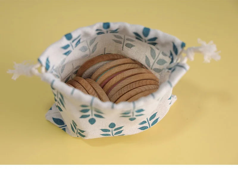 Colorful wooden sensory discs in a fabric bag, ideal for a therapeutic touch activity toy
