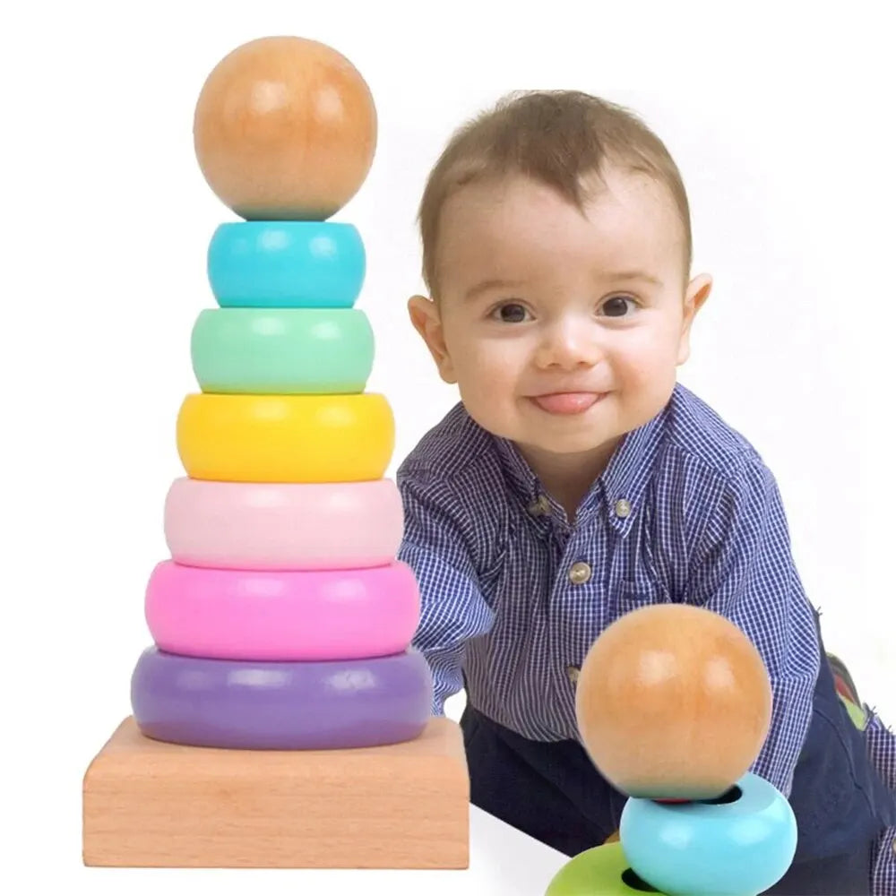 Child playing with a wooden rainbow stacking tower featuring colorful rings for developmental skills