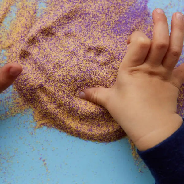 Childs hands playing in sand