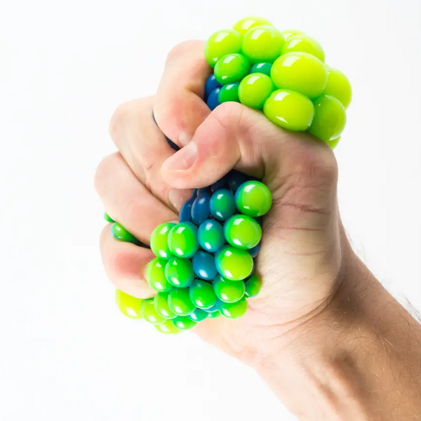 Hand squeezing colorful stress relief toy highlighting the benefits of fidget toys for adults