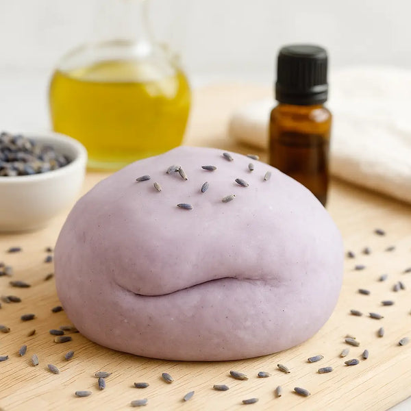 Soft purple scented sensory dough with dried lavender and essential oil on wooden board