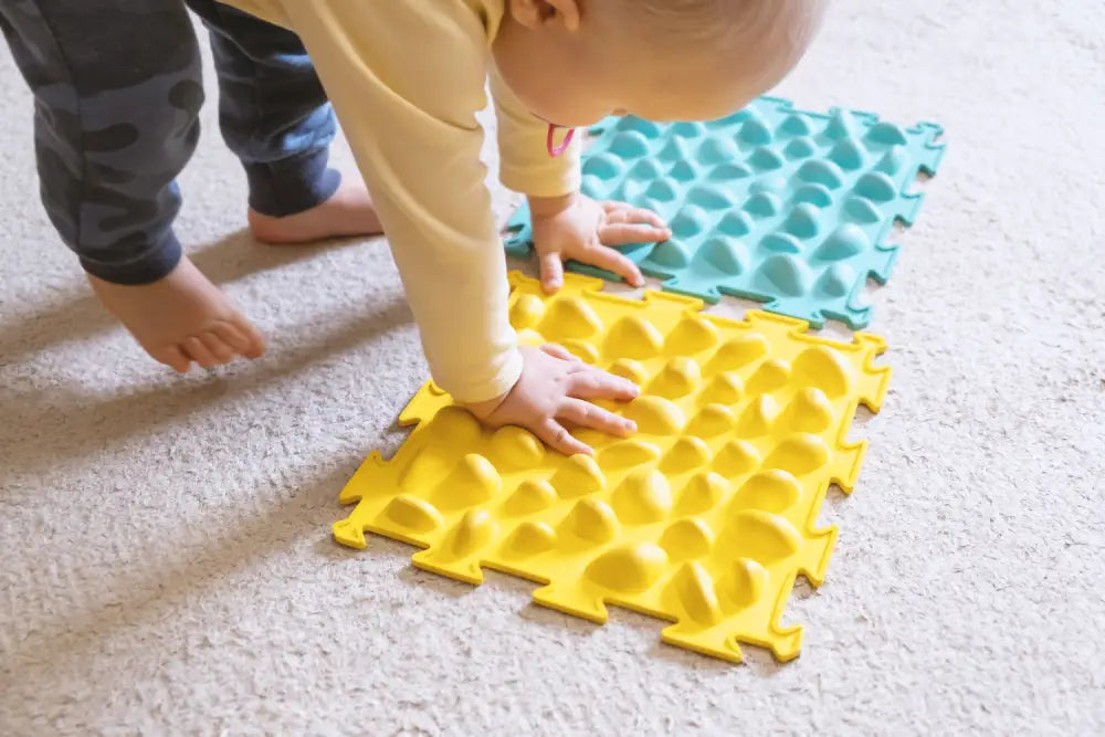 Baby playing with tactile mat