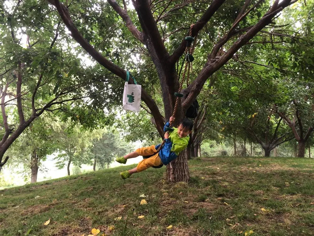 Kids climbing rope swing with disc footholds, view 6