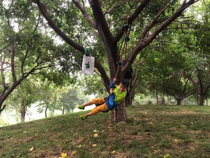 Kids climbing rope swing with disc footholds, view 6