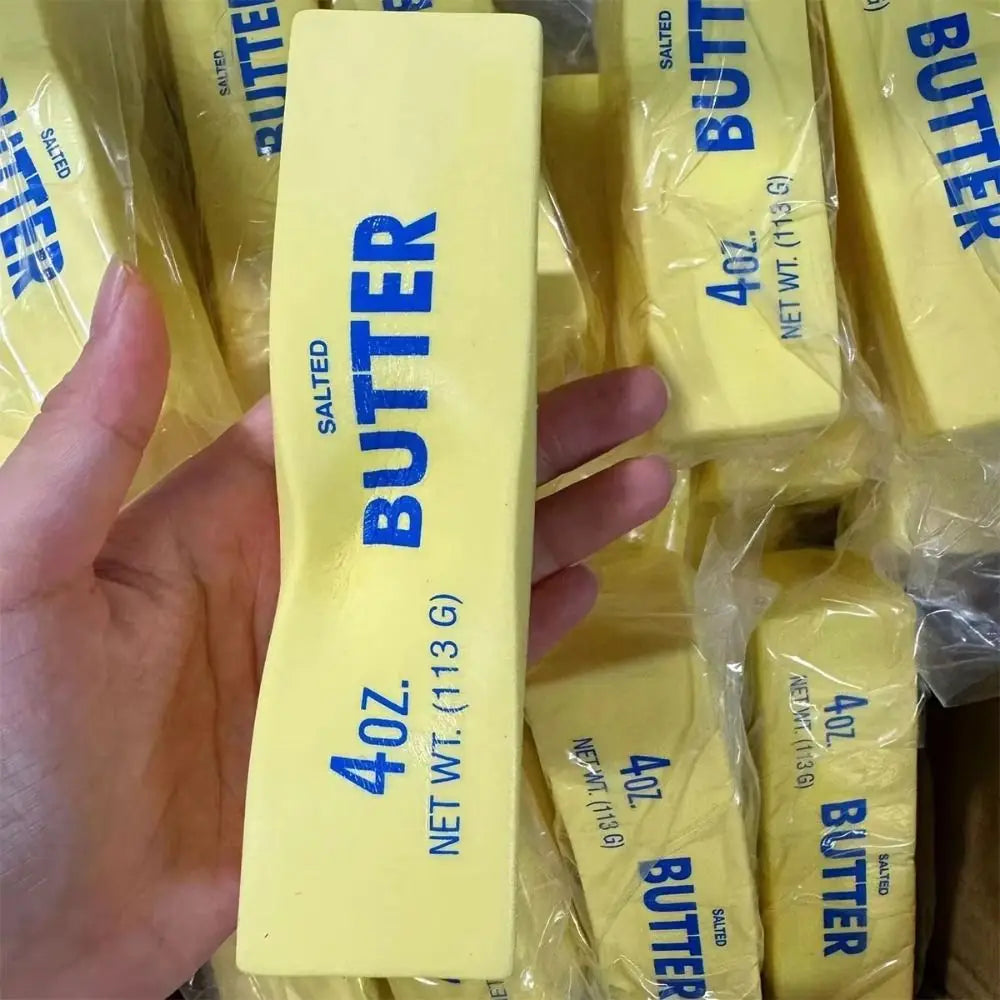 Hand holding a realistic butter stick squishy