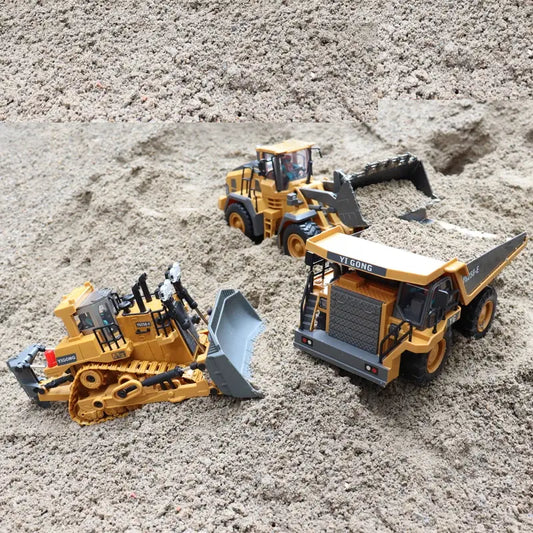Alloy remote controlled construction toys in action on sand, featuring a bulldozer and dump truck