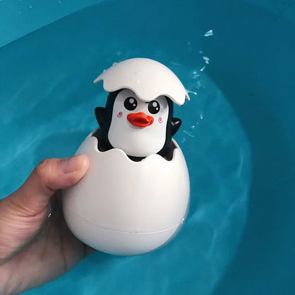 Cute penguin baby bath toy water spray that pops from an egg for fun bath time activities