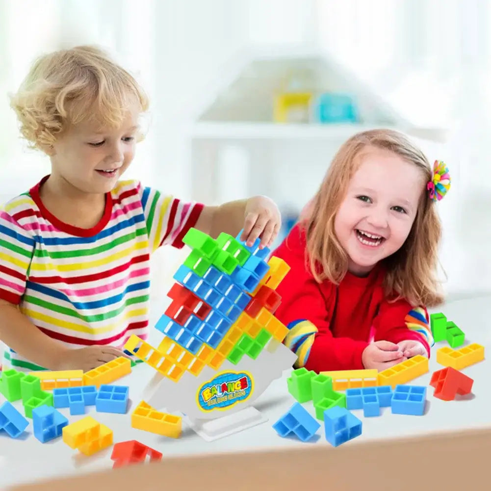 Children playing with a balance stacking game featuring colorful blocks for developing fine motor skills