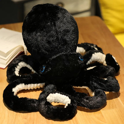 Black octopus plush toy with soft texture and vibrant blue eyes, perfect for cuddling