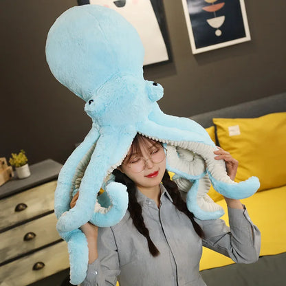 Woman holding a large blue octopus plush toy with soft fabric and floppy tentacles