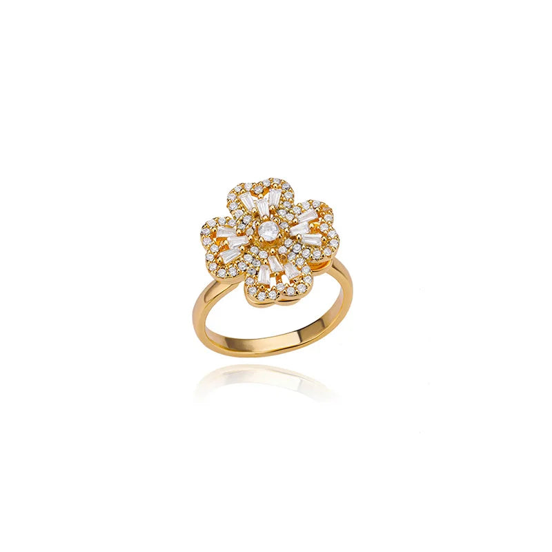 Adjustable therapeutic fidget ring with gold band and flower-shaped design adorned with white stones
