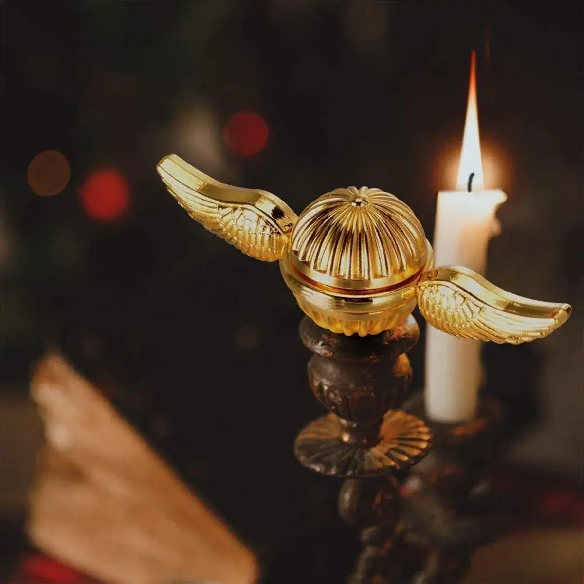 Gold magic fidget spinner on a candle holder, perfect for stress relief and fun playtime