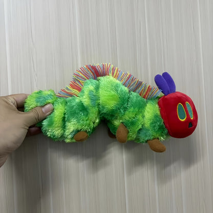 Active Playthings green caterpillar plush toy with red head and colorful yarn antennae held by hand