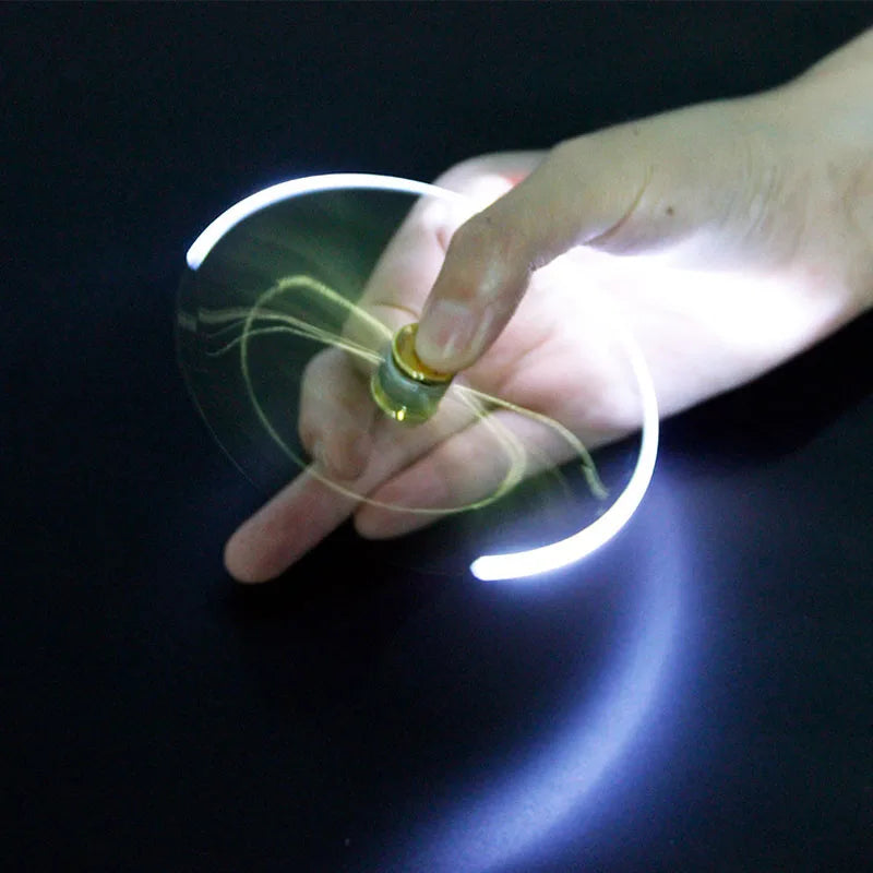 A hand spinning the Gyro Pen Fidget Spinner with glowing LED lights for fun and relaxation