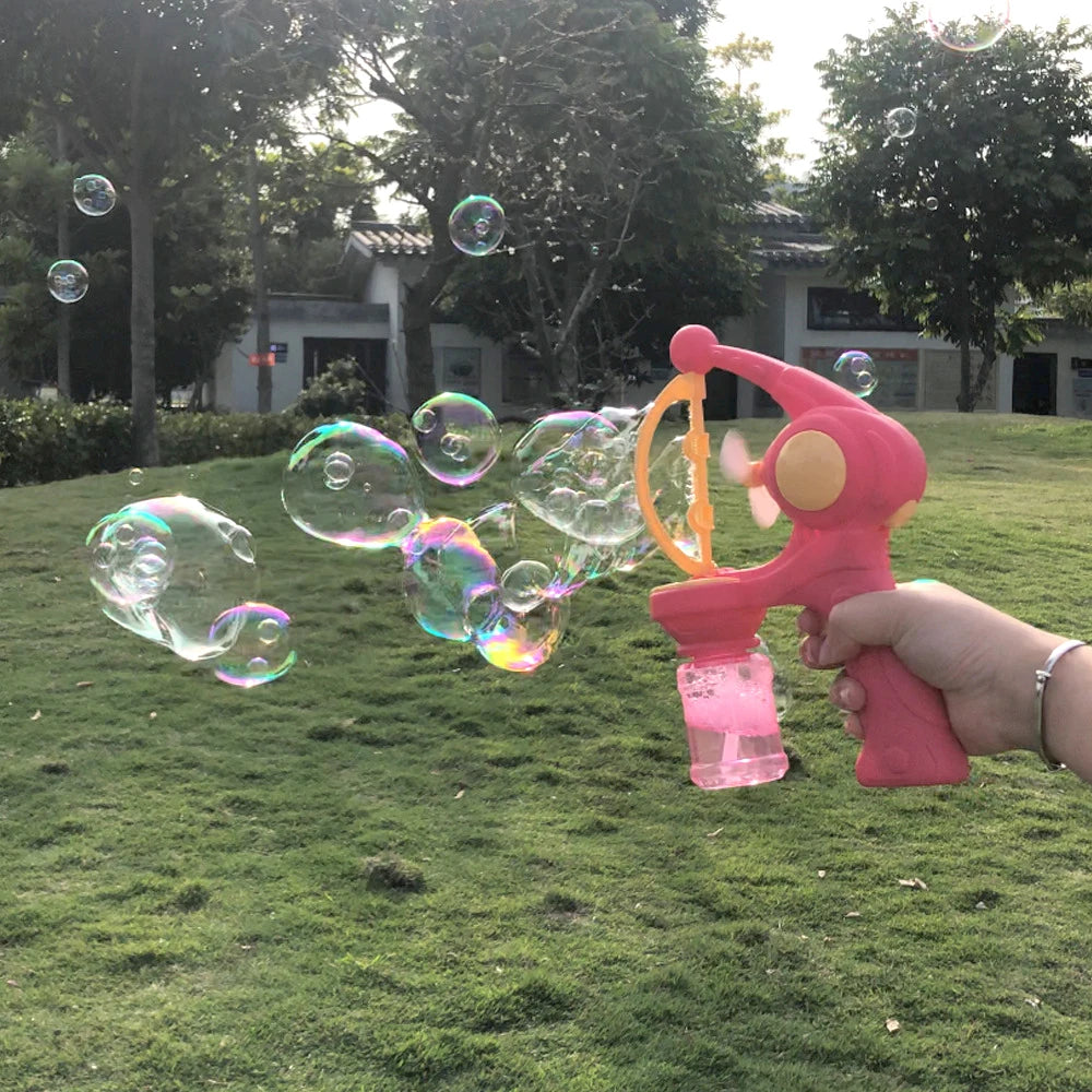 Colorful pink 8-hole bubble gun for kids creating large bubbles outdoors in a park
