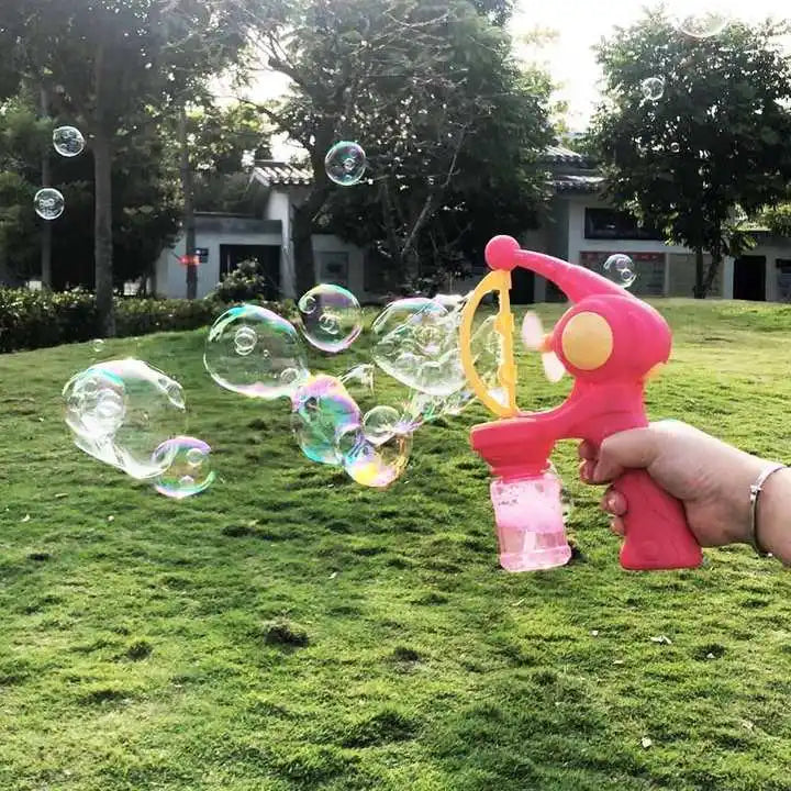 Pink 8-hole bubble gun for kids creating colorful bubbles in a grassy outdoor setting
