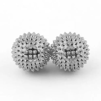 Set of two silver magnetic acupoint massage balls with textured surfaces for enhanced relaxation