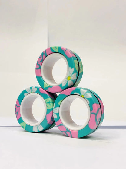 Colorful floral magnetic finger ring fidget toy stacked in a fun arrangement for stress relief