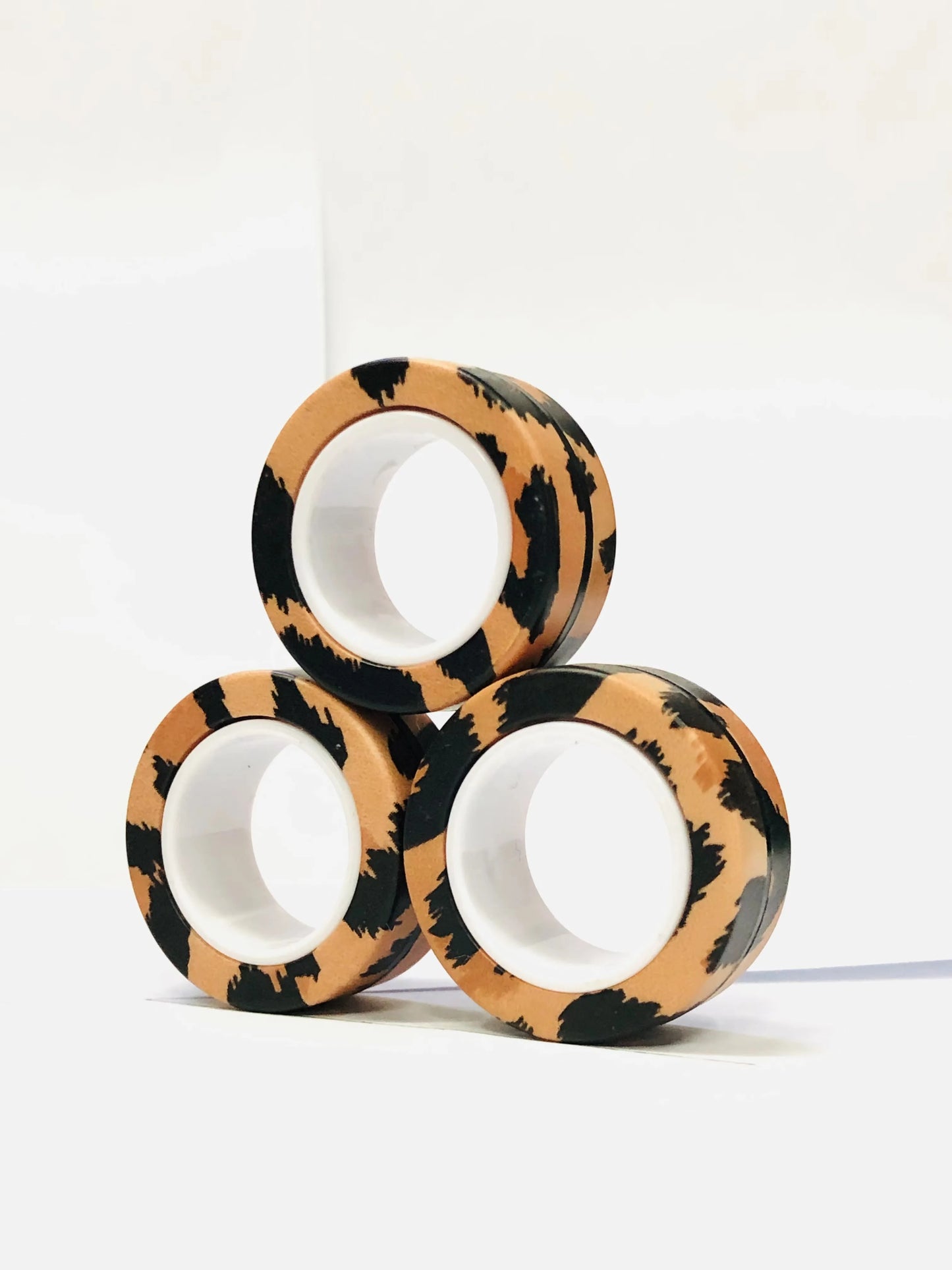 Three colorful magnetic finger ring fidget toys in a fun animal print design