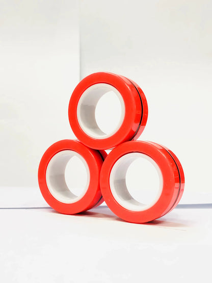 Three red magnetic finger ring fidget toys stacked in a triangular shape for stress relief and focus