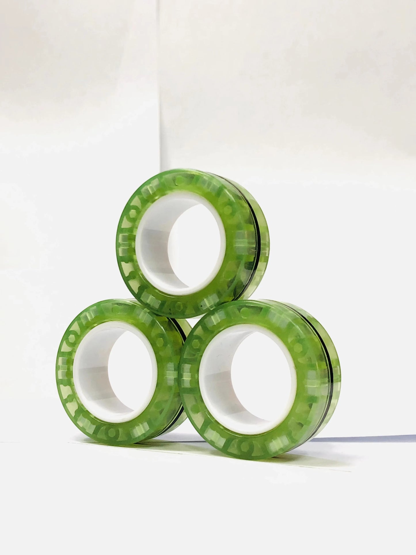 Three green magnetic finger ring fidget toys designed for stress relief and focus enhancement