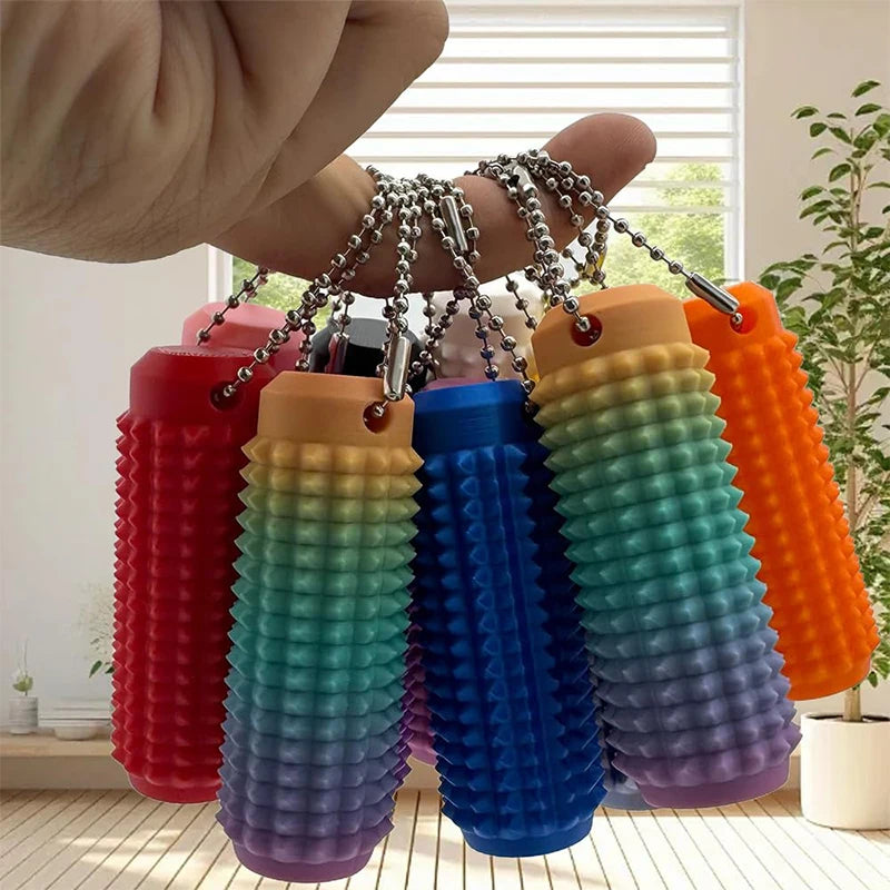 Colorful mini grippie sensory toy collection hanging from a hand, ideal for tactile play.