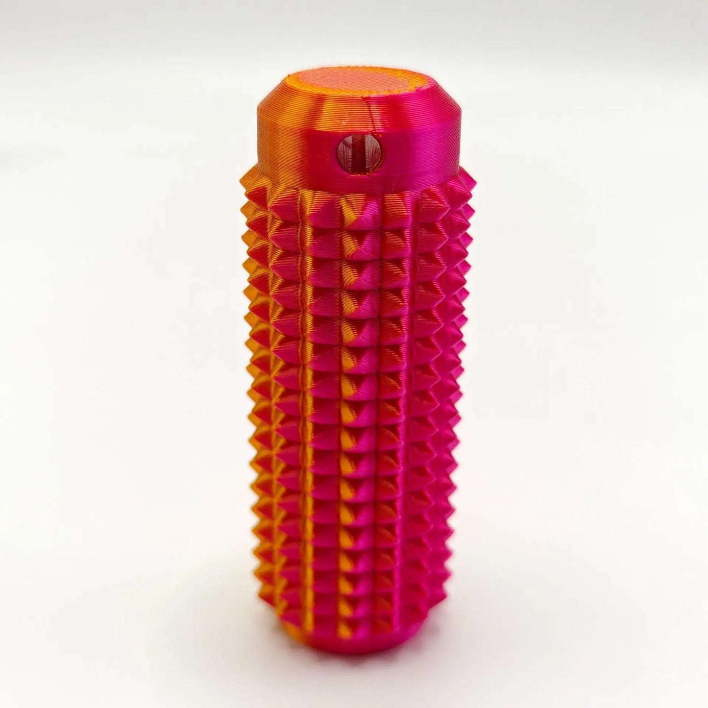 Bright pink and orange mini grippie sensory toy with a textured design for tactile engagement