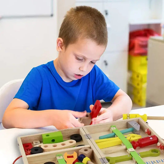 Child focused on building with the Montessori carpenter play set from Active Playthings