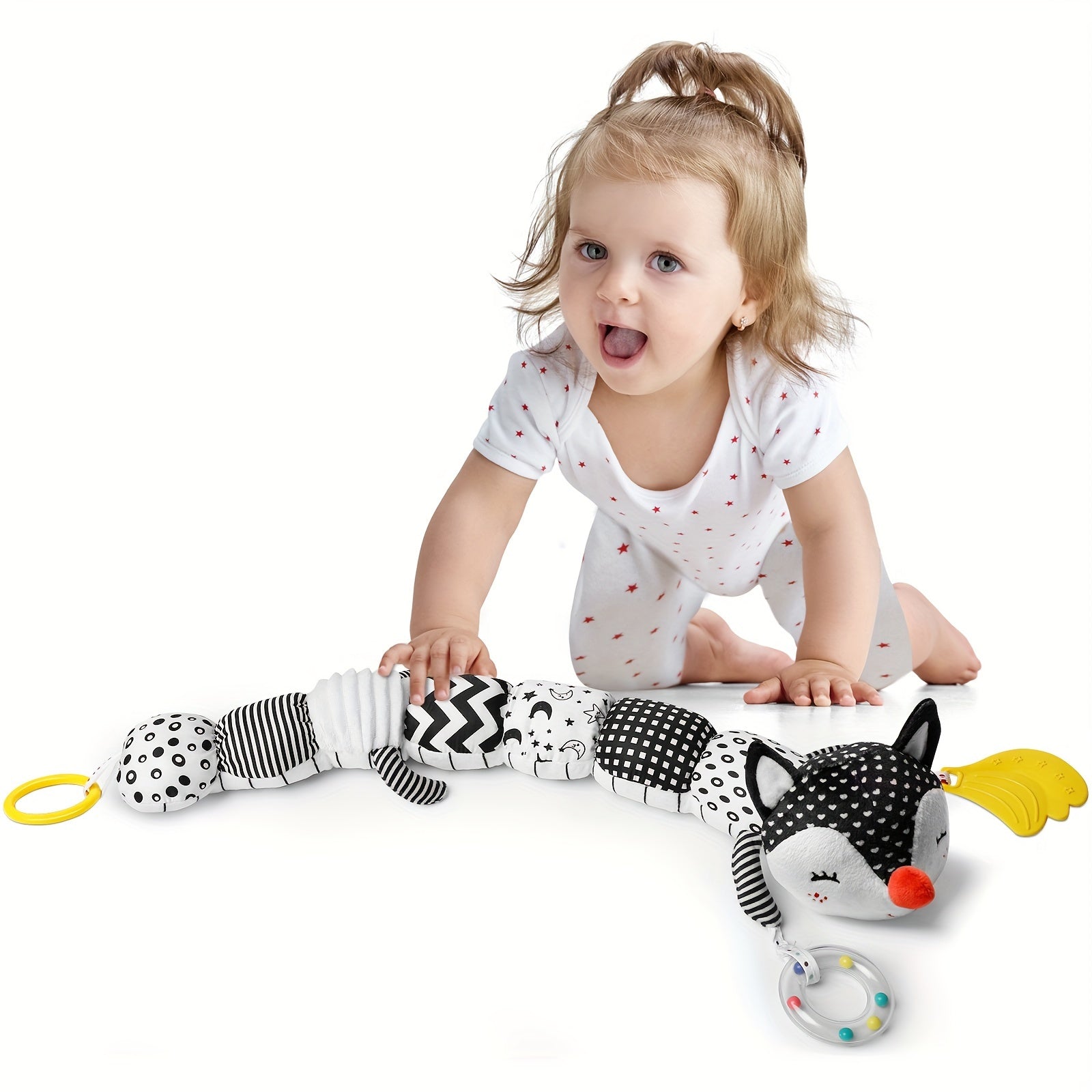 Baby playing with black and white musical stuffed animals for babies soft toy with ring and textured fabric