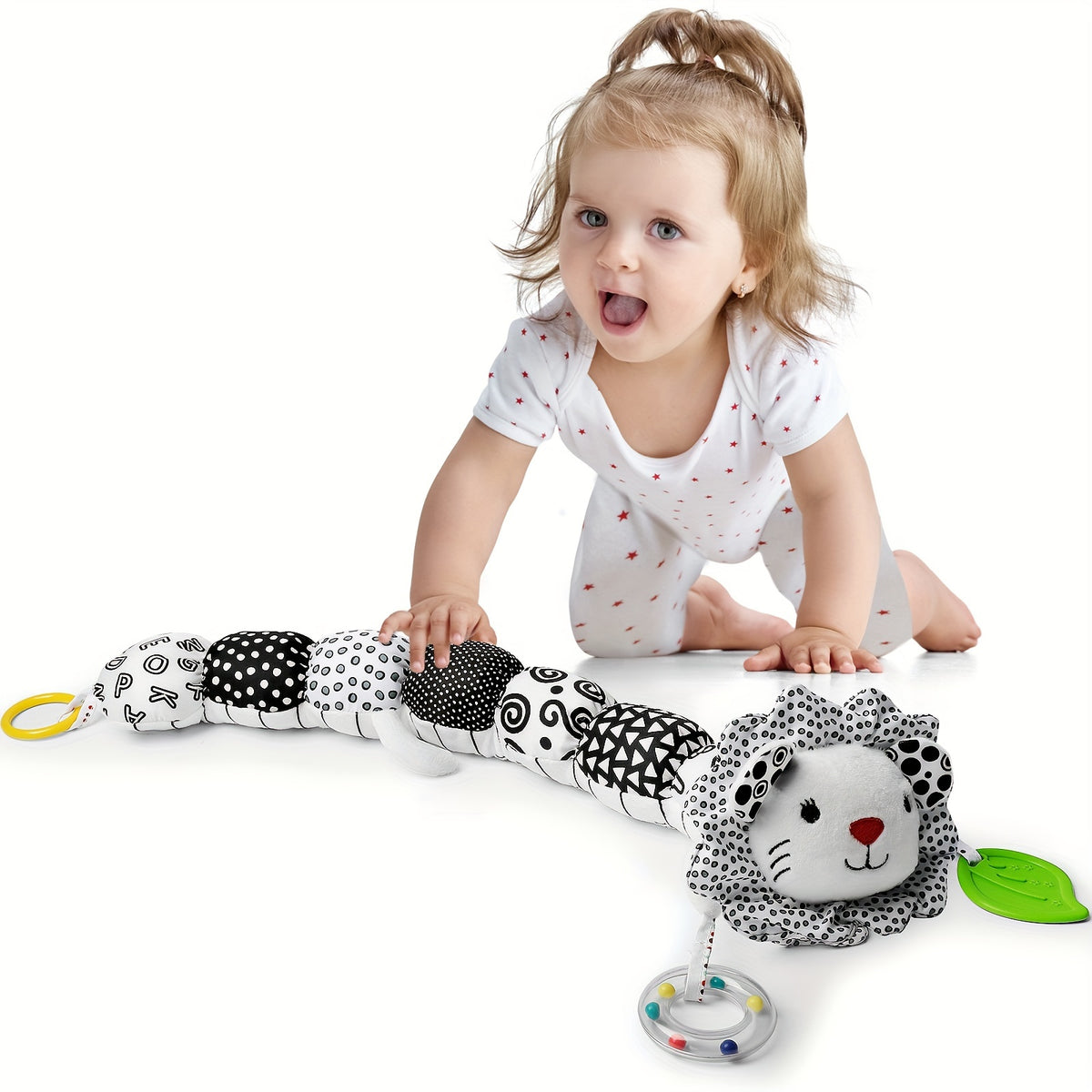 Baby playing with black and white musical stuffed animals for babies lion toy by Active Playthings