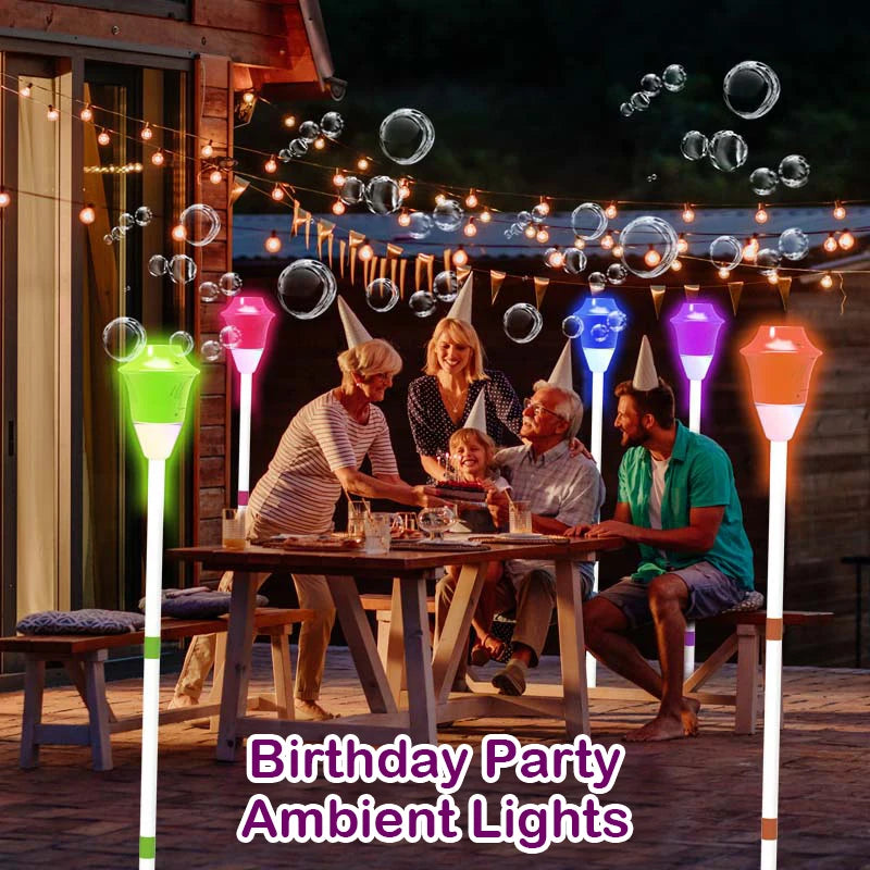 Outdoor birthday party with multicolor bubble street lamp sensory light stakes glowing around family table