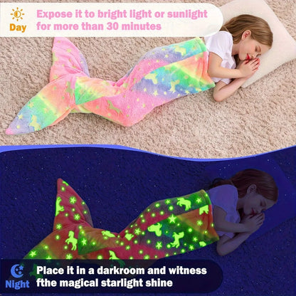 Rainbow mermaid tail blanket glowing in the dark with vibrant colors and starry designs