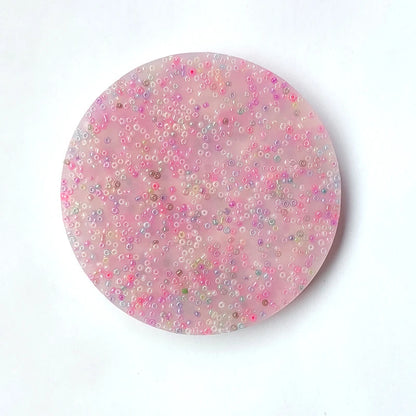 Pink sensory fidget toy with colorful beads, designed for skin picking relief and stress reduction