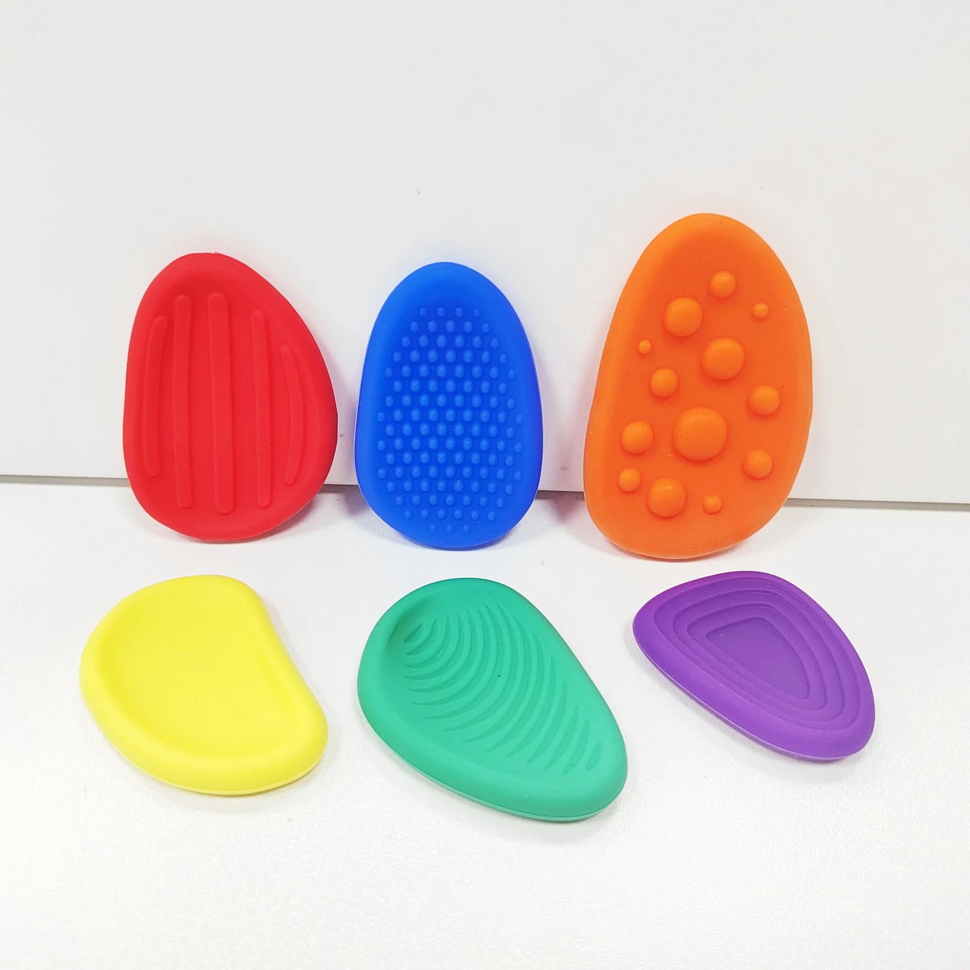 Colorful set of sensory silicone fidget toys in various shapes and textures for stress relief and mental focus