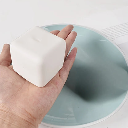 Hand holding squishy tofu stress ball from ActivePlaythings for sensory relief and stress management