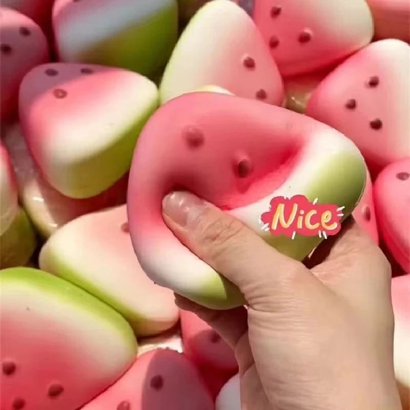 Hand squeezing a squishy watermelon stress toy for relaxation and fun