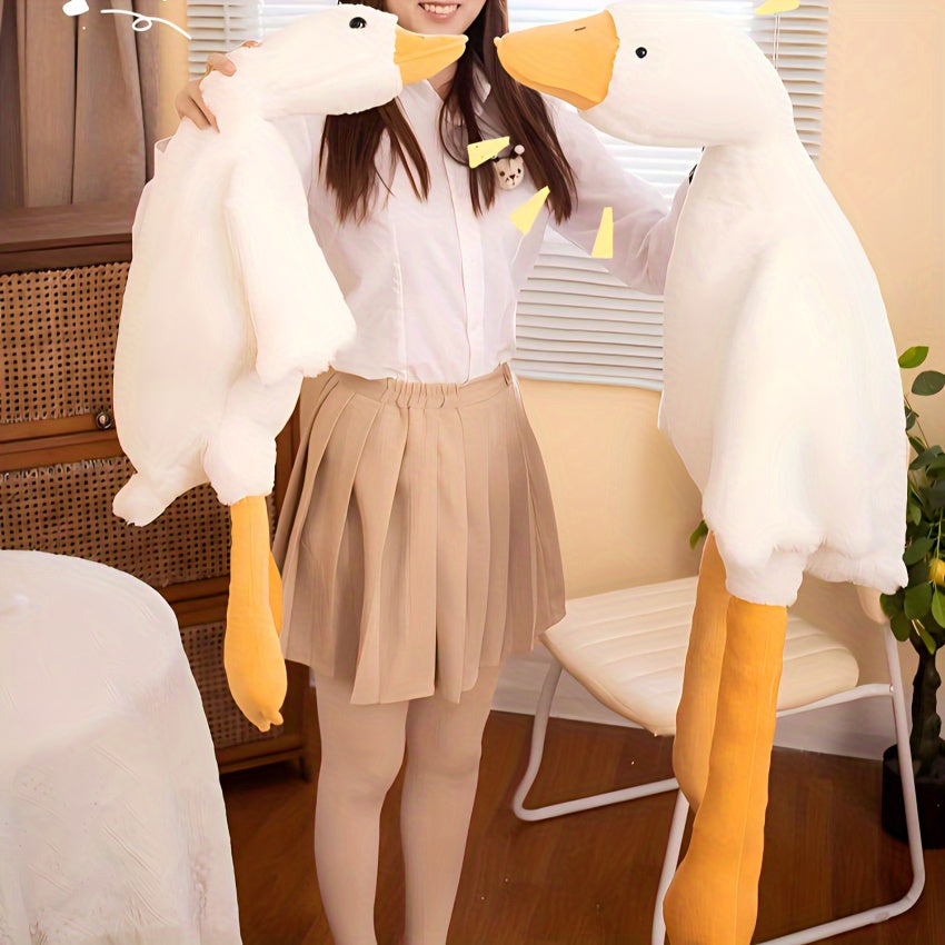 White goose plush toy held by woman wearing beige skirt and white shirt indoors