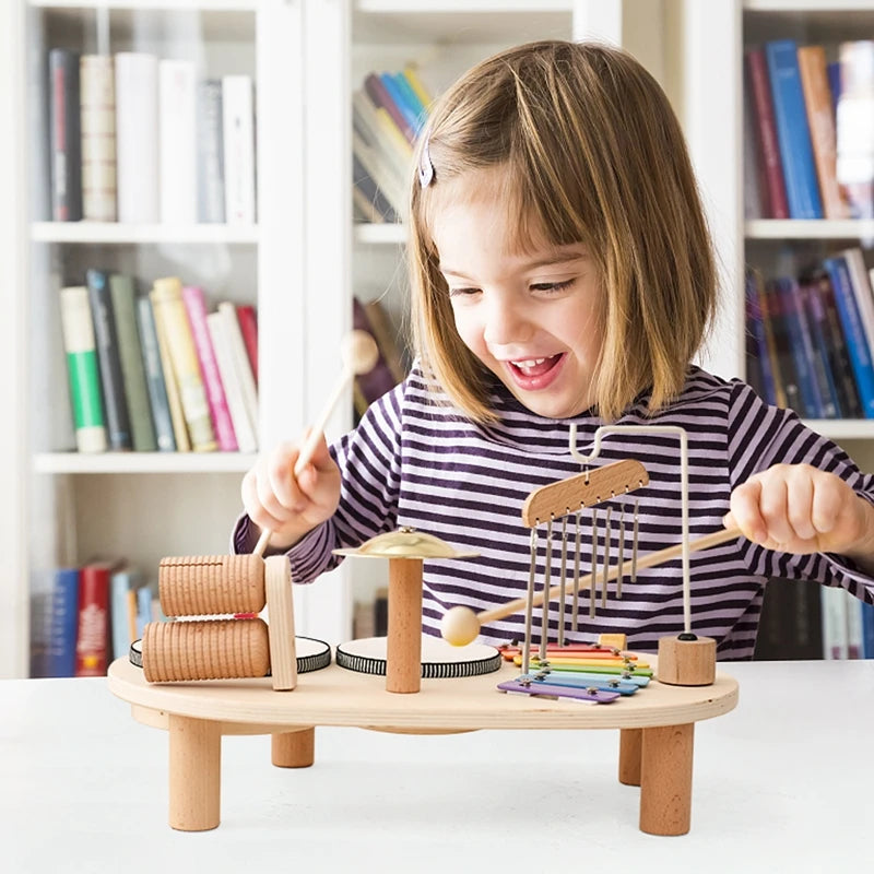 Child playing with a wooden mini band stand toy featuring various musical instruments and imaginative play