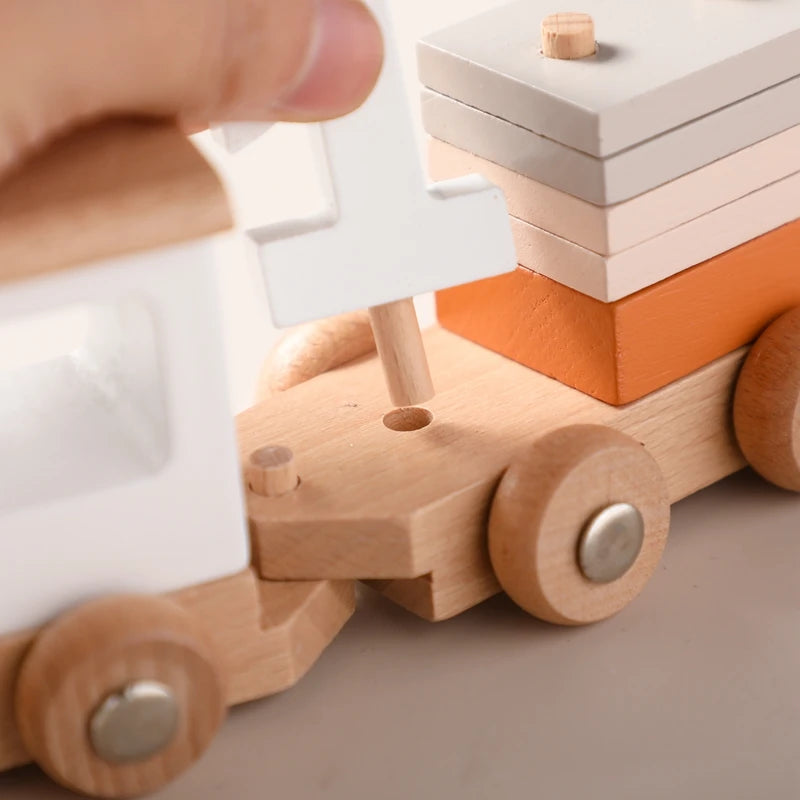 Child playing with a wooden train educational toy featuring colorful stacking blocks for creative learning